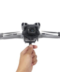 Person holding Grab And Go Handheld Drone Mount For DJI Mini 5 Pro, demonstrating seamless one take aerial to ground shooting capability.