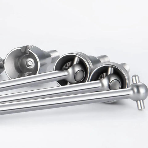 Beefy 4 Piece RC Front And Rear CVD Driveshaft Set For One Sixteenth Scale Trucks Like HBX 16889A I Mex Katana Shogun And Red Cat Volcano16 Upgrade Parts CNC Machined Metal Shafts For Durability - Close-up of silver CNC-machined metal driveshafts emphasizing design and structure.
