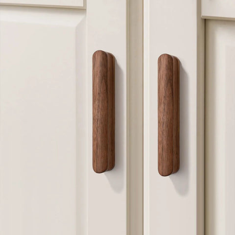 Walnut Wood Drawer Pulls Set Six Pack 5.04 Inch Length With Rounded Edge For Cabinets; two walnut pulls on white cabinet doors