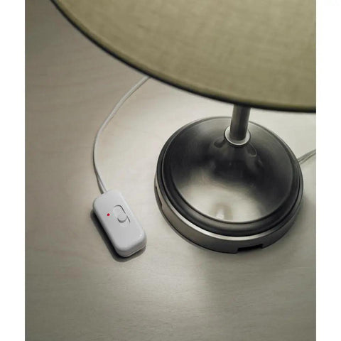 Credenza Plug-In Dimmer for Incandescent and Halogen Lamps With Locator Light next to a table lamp base, white finish