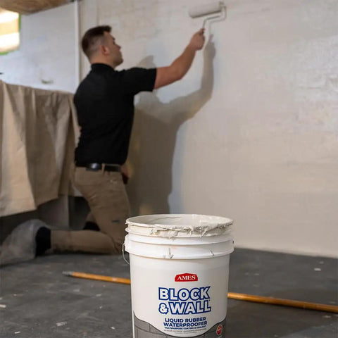 Person applying Block And Wall Liquid Rubber Waterproofer Pro Grade Multi Purpose Coating And Sealant For Concrete Walls And Foundations 1 Gallon White Made In USA Waterproof Basement Sealer on wall.