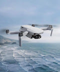 Mini 4K Camera Drone Bundle With Case And Extra Battery Under 249 Grams 3 Axis Gimbal flying over ocean
