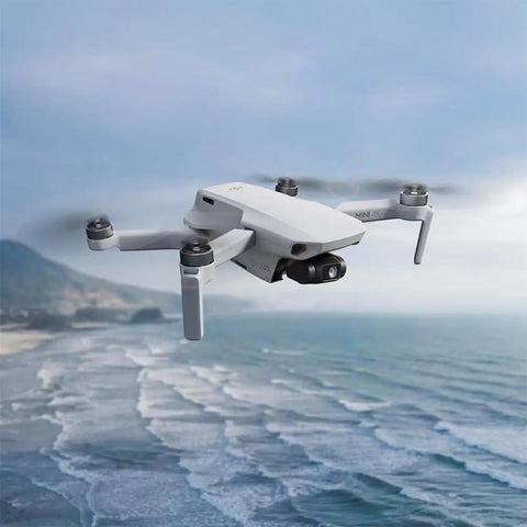 Mini 4K Camera Drone Bundle With Case And Extra Battery Under 249 Grams 3 Axis Gimbal flying over ocean