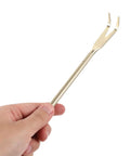 Hand holding a Stainless Steel Bonsai Rake And Tweezers Set For Potted Plants Pro Grade Gardening Tools For Loosening Soil And Shaping Bonsai Durable Potting Kit For Enthusiasts With Handy Grip For Easy Handling