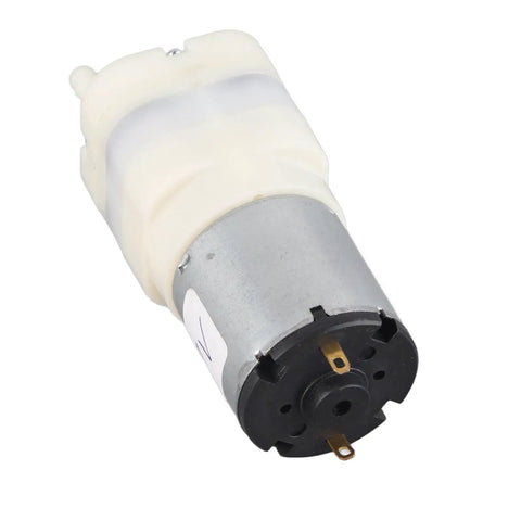 Rock Solid Mini Micro Air Vacuum Pump Running Next Level Quiet With Low Voltage Safety Design Knockout High Performance And Compact Durability in white and silver with a plastic body.
