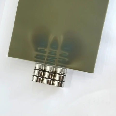 4x6 Inch Magnetic Field Viewing Film With Green Visual Aid displaying magnetic flux patterns with steel rings underneath