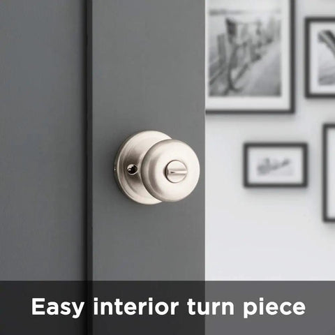 Juno Interior Privacy Door Knob With Lock For Bedroom And Bathroom Satin Nickel Finish No Fuss Keyless Turn Lock Microban Protection Easy DIY Install In Minutes, shown on a closed door with wall art in background