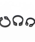 Heavy Duty Internal Shaft Circlips Top Shelf Manganese Steel Precision Retaining Rings set of three sizes on white background.