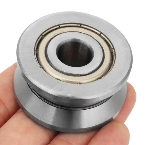 Top Shelf Sealed Metal V Groove Track Roller Guides With Precision Ball Bearings Designed To Handle Heavy Machinery And Equipment Without Skipping A Beat At 12X41X20MM Dimensions held in hand.