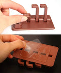 Hand demonstrating installation of Slick Rotary Sticky Hook Wall Mount With Heavy Duty Adhesive Grip for keys and coats.