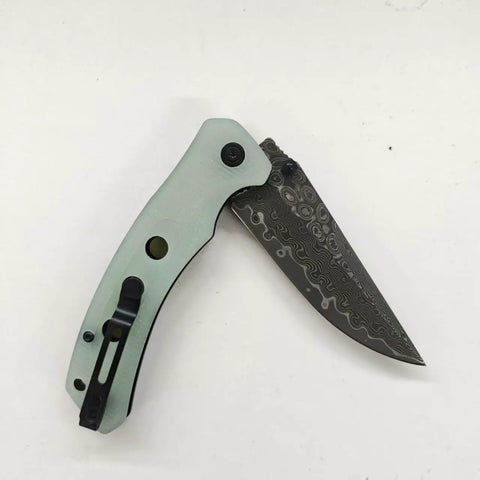Damascus Pocket Folding Knife with 3.26 Inch Sharp Blade and G10 Handle, open position displaying unique Damascus pattern