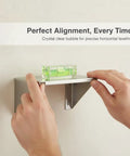 Hands using a Bubble Level Vial, Spirit Level for precise horizontal leveling on a shelf.