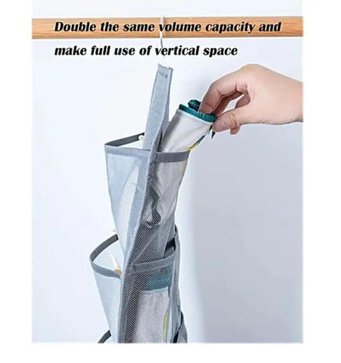 Hand placing socks into Double Sided Hanging Closet Organizer With Thirty Roomy Pockets In Gray, designed to maximize storage.