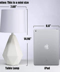 Modern White Ceramic Table Lamp With Irregular Geometric Base And White Fabric Shade Compact Nightstand Bedside Lamp For Bedroom Living Room Or Office 15 Inch Tall 7 Inch Diameter Sleek Decor Accent next to an iPad for size comparison