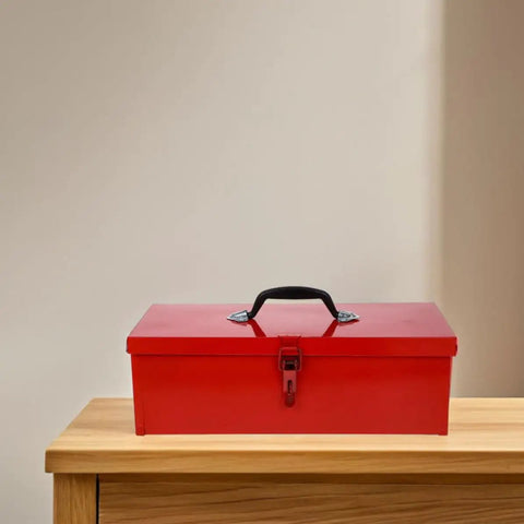 Slick Red Metal Toolbox Chest With Reinforced Carry Handle For Portable Gear Storage And Heavy Duty Tool Organization on a wooden surface.