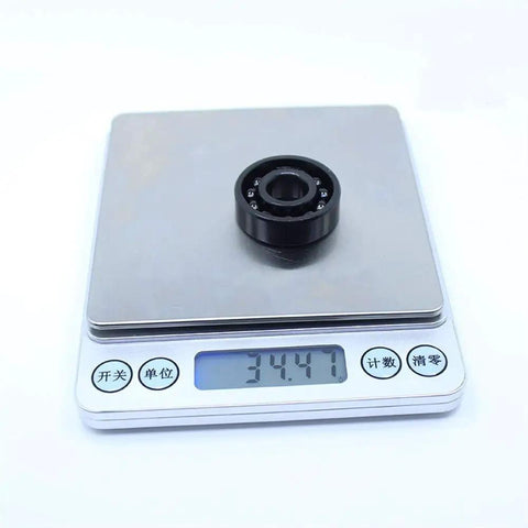 Heavy Duty TB6201 High Temp Full Ball Bearing 12X32X10Mm rated to 500C on a scale, weighs 34.47 grams, showcasing precision engineering.