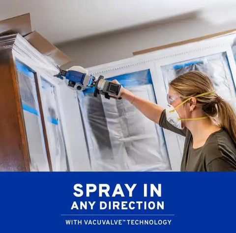 User applying Portable Cordless Drill Connect Paint Sprayer Featuring A Compact Application Cup And High Pressure Output for indoor wood staining.