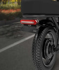 Ultra Bright E Bike Taillight With Turn Signals And Brake Sensor That Lights Up instantly For Night Riding Safety On Any Scooter Or Electric Cycle mounted on rear wheel