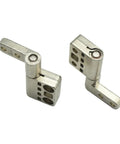 Damping hinge components, two silver metal pieces with perforated blocks and pivot joints.