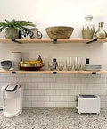 Wall-mounted shelves supported by 12 Inch Heavy Duty Floating Shelf Brackets Set of 6 Industrial Black Iron Wall Mounted Shelf Supports.