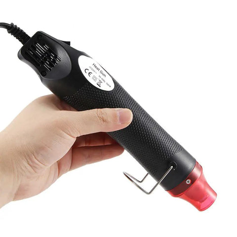 Mini Heat Gun For DIY Projects, Quick Embossing, Shrink Wrap, Paint Drying, 110V Electric Hot Air Tool in hand