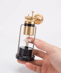 Hand holding Retro Three Legged Oscillating Steam Engine Model Kit For Hands On STEM Fun, Easy 80 Percent Preassembled Build
