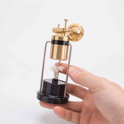 Hand holding Retro Three Legged Oscillating Steam Engine Model Kit For Hands On STEM Fun, Easy 80 Percent Preassembled Build