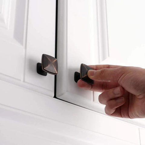 Hand reaching for Ten Pack Oil Rubbed Bronze Cabinet Knobs Set For Cabinets And Drawers Square Single Hole Pulls For Dresser Cupboard Bedroom