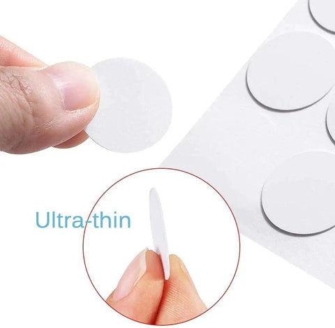 Close-up of self-adhesive screw hole covers showing ultra-thin white PVC stickers, highlighting texture and thickness.