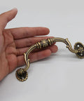 Person holding European Style Drawer Handles Set Of 10 No Drill Cupboard Pull Knobs for cabinets and dressers, classic design