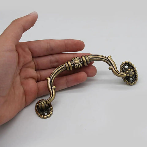 Person holding European Style Drawer Handles Set Of 10 No Drill Cupboard Pull Knobs for cabinets and dressers, classic design