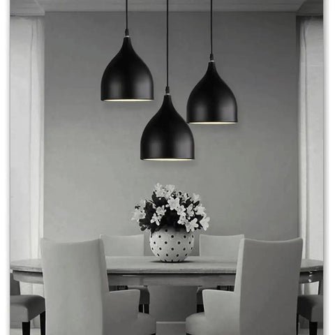 Dark Antique Farmhouse Pendant Light with Single Hanging Shade featuring three black suspended shades above a dining table.