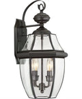 Two Light Outdoor Wall Lantern In Antique Brass Finish For Patio And Entry, Classic Newbury Style Mount Light, close-up view.