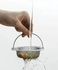 Ditch the Plumbing Headache Forever with This Tough Stainless Steel Sink Strainer Mesh Drain Catcher Filter Screen catching food crumbs.