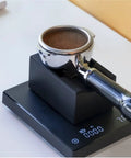 Solid Kickass Coffee Tamping Station With Integrated Espresso Scale Base and Grippy Silicone Portafilter Rest for quicker ground coffee weighing, close-up view.