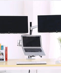 Total Game Changer Dual Articulation Monitor And Laptop Desk Stand With Slick Gas Spring Arms holding two monitors and a laptop.