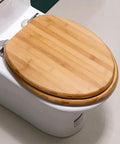 Heavy Duty Solid Wood Elongated Toilet Seat With Smooth Soft Close Lid Quick Release Hardware And Nonslamming Design top view on toilet.