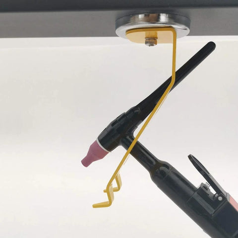 TIG welding torch holder mounted under workbench; 50lb magnetic base, yellow arm, black torch