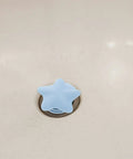 2pcs Silicone Star Bathtub Stopper for Bath Drain, Flat Cover in light blue over bathtub drain.