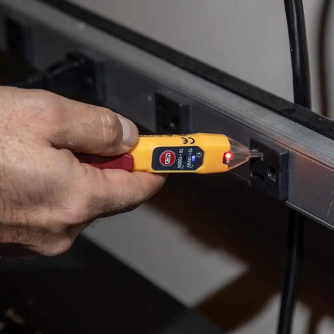 Non Contact Voltage Tester With Outlet Tester Dual Range 12 To 48V AC And 48 To 1000V AC in use, detecting live cables and wiring