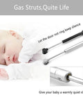 80N Heavy Duty Hydraulic Gas Struts 6 Pack Soft Close Lid Supports for Cabinets and Furniture shown beside a sleeping baby.