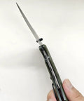 Damascus Folding Knife With Super Sharp 3.26 Inch Blade And Tough G10 Handle Liner Lock EDC opened in hand, side view angle