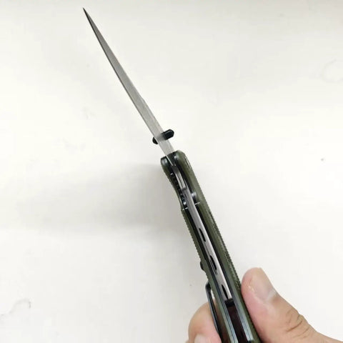 Damascus Folding Knife With Super Sharp 3.26 Inch Blade And Tough G10 Handle Liner Lock EDC opened in hand, side view angle