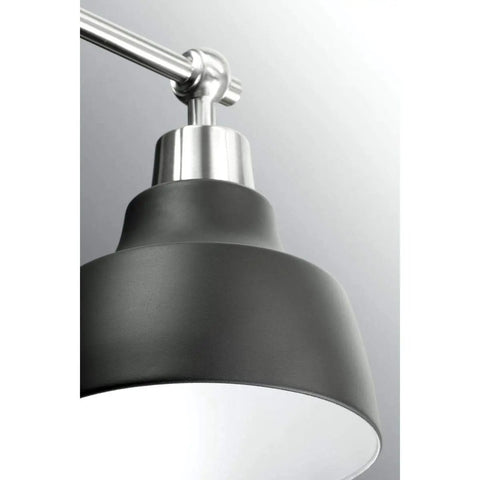Close-up of Bramlett Bath And Vanity Light in nickel finish, showcasing industrial vintage style fixture details.