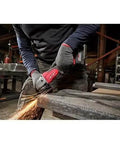 Beefy Brushless Cordless Angle Grinder With Tool Free Disc Swap And Kickass Battery Setup For Heavy Duty Cutting And Grinding Operations On The Site Or Garage Every Single Task, cutting metal with sparks.