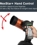 Hand holding NexStar 4SE Computerized Telescope With 4-Inch Maksutov-Cassegrain Optics, Fully Automated GoTo Mount With SkyAlign