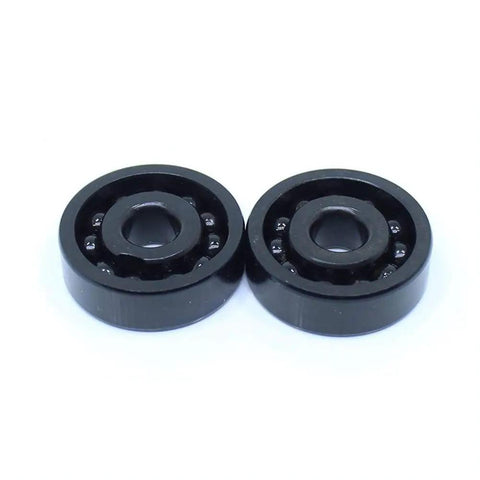Top Shelf TB16003 High Temp 500C Rock Solid Full Ball Thin Section Bearing 17mm By 35mm By 8mm Heat Proof Chromium Steel showing two black thin ball bearings.