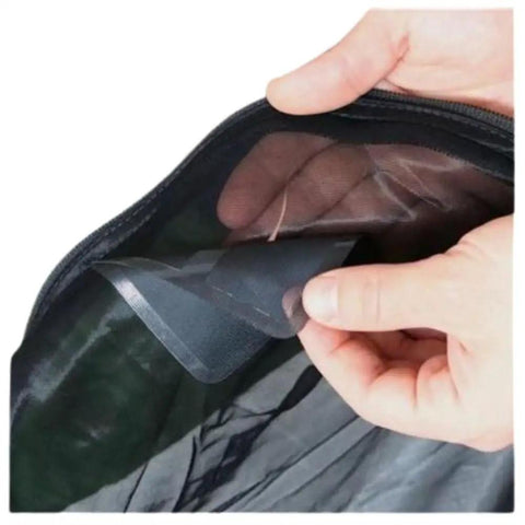 Applying Self-Adhesive Mesh Repair Patches Kit For Tent Screens And Mosquito Netting on a torn screen, durable 3 by 3.5 inches