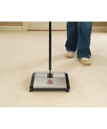 Lightweight Manual Carpet And Hard Floor Sweeper Featuring Dual Rotating Brush Roll Plus Corner Edge Brushes Straight Up Picks Up Pet Hair And Crumbs in use on carpet