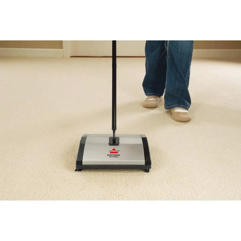 Lightweight Manual Carpet And Hard Floor Sweeper Featuring Dual Rotating Brush Roll Plus Corner Edge Brushes Straight Up Picks Up Pet Hair And Crumbs in use on carpet